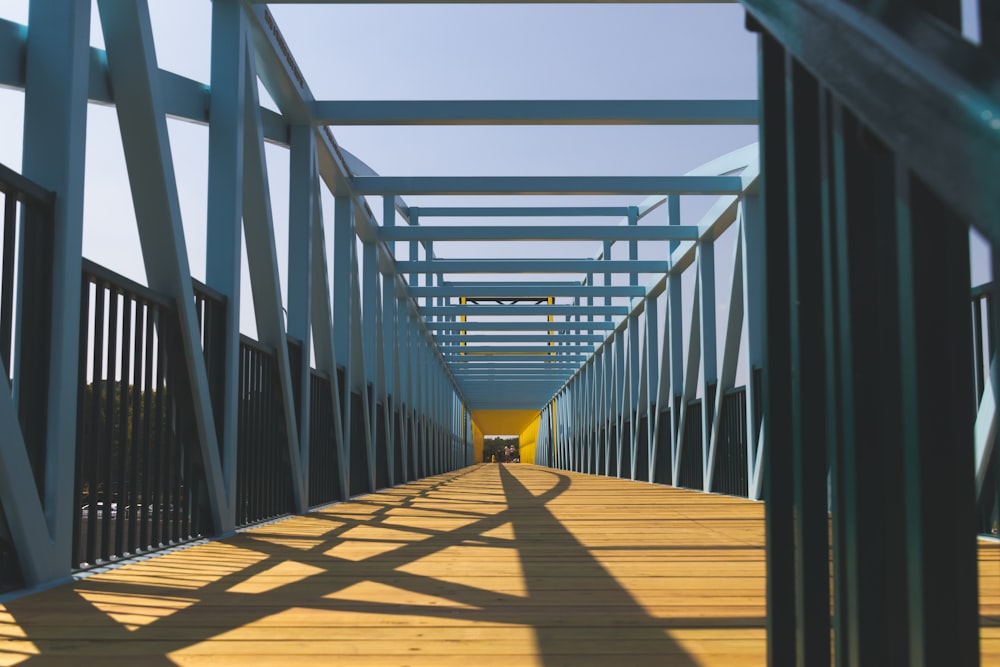 brown wooden bridge under blue sky during daytime