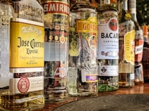 clear glass bottles on gray concrete floor