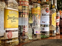 clear glass bottles on gray concrete floor