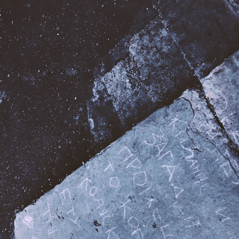 Close-up of a skilled craftsman smoothing a freshly poured concrete driveway under moody industrial lighting.