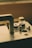 A close-up of a vintage sewing machine with intricate details and a warm wooden finish.