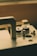 A close-up of a vintage sewing machine with intricate details and a warm wooden finish.