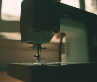 white sewing machine on table