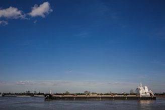 boat on sea under blue sky during daytime