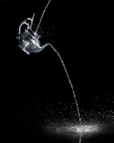 water pouring from clear glass mug
