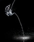 water pouring from clear glass mug