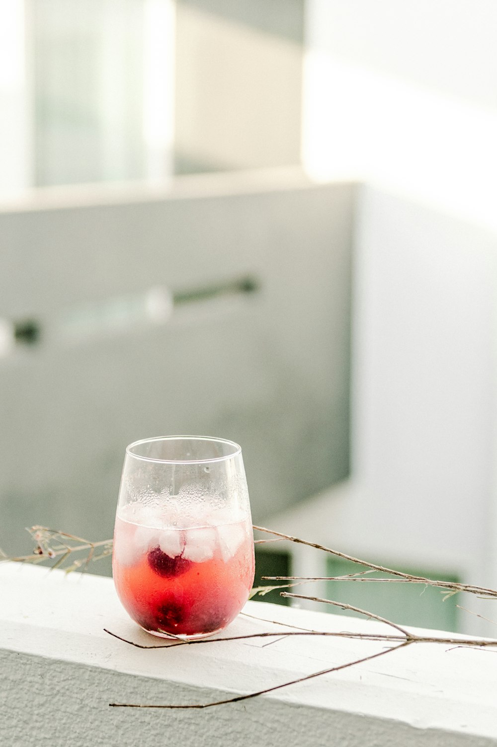 clear wine glass with red wine on white table