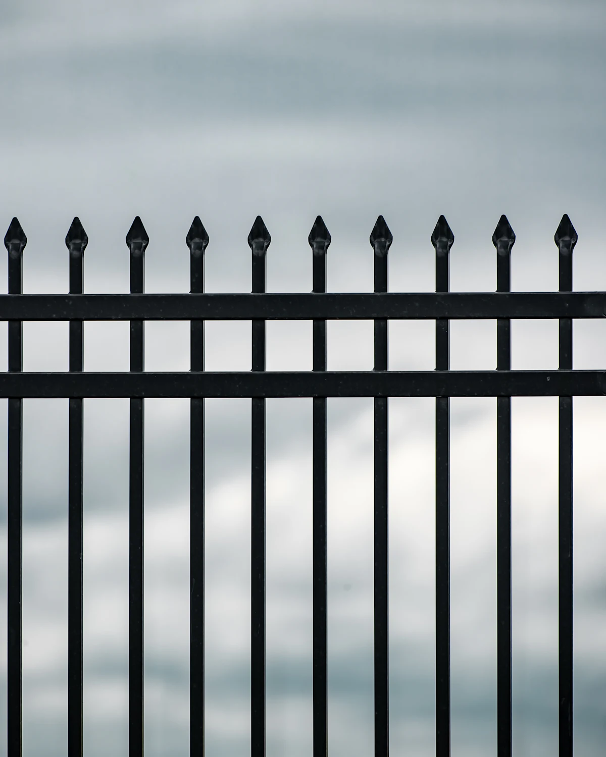 Black aluminum ornamental fence in daylight