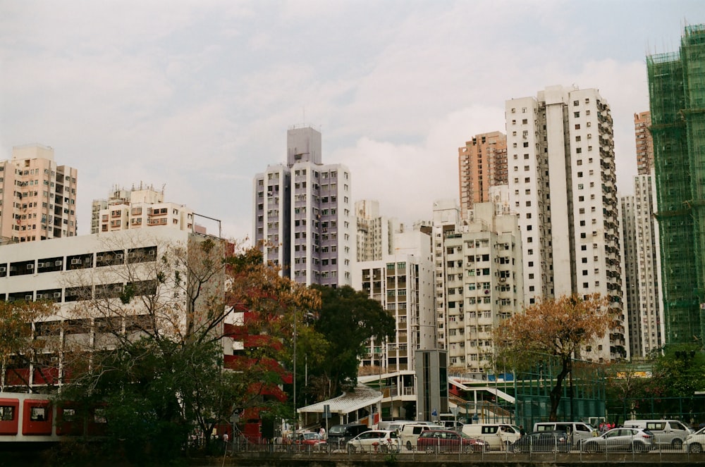 white and brown concrete building near green trees during daytime