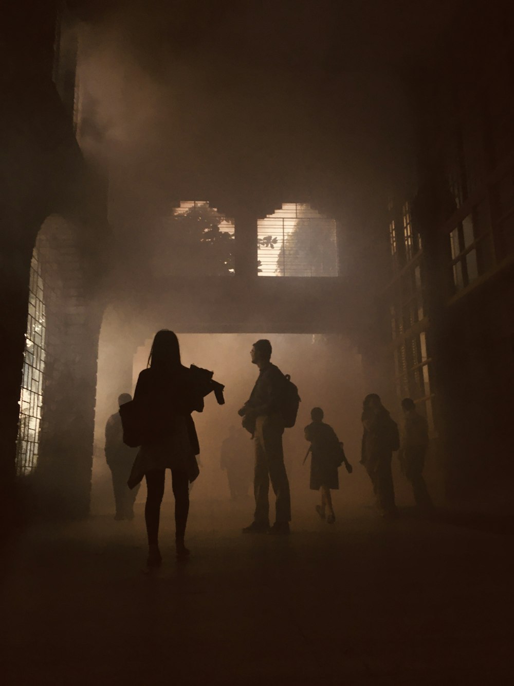 silhouette of people walking on street during night time