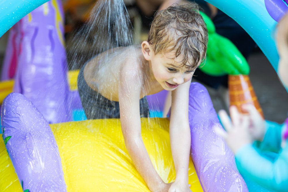 girl in pink shirt on yellow inflatable ring