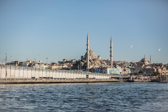 white concrete building near body of water during daytime in New Mosque Turkey