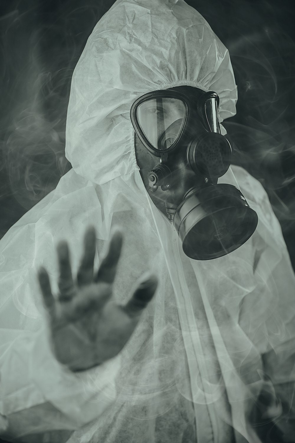 person wearing gas mask in grayscale photography