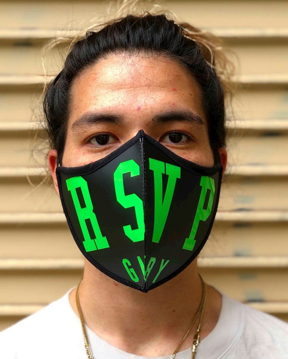 man in white shirt wearing black and green mask