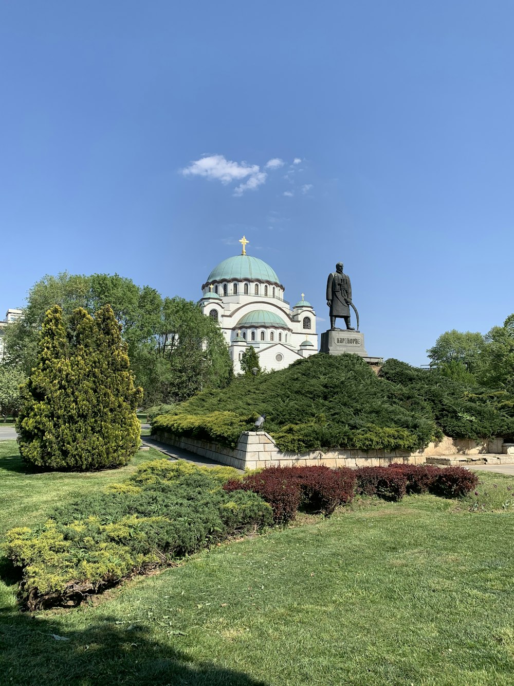 white and blue dome building surrounded by green trees under blue sky during daytime