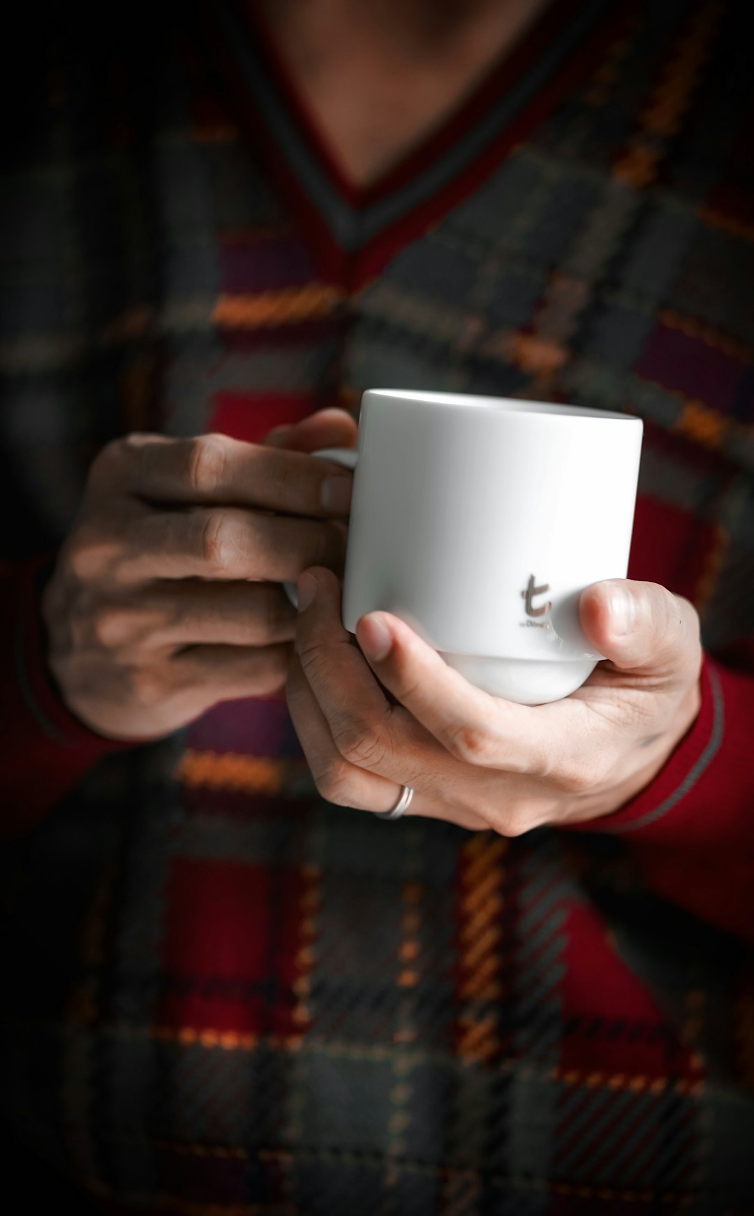 person holding white ceramic mug