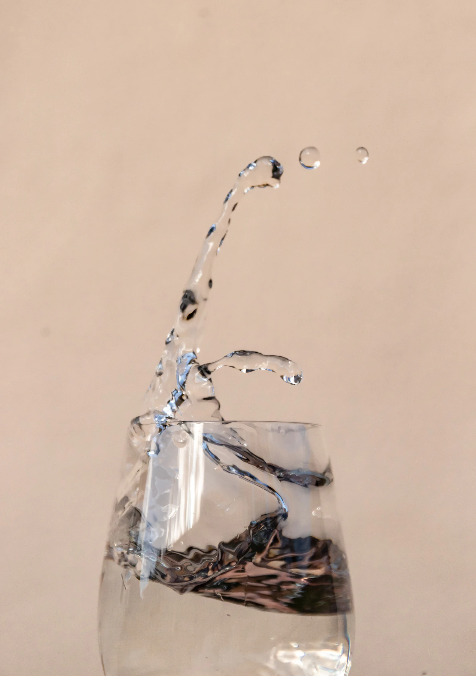 Water pouring from a tap into a clear drinking glass