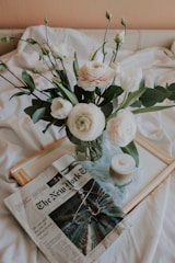 Fresh flowers in a vase on a bedside table.
