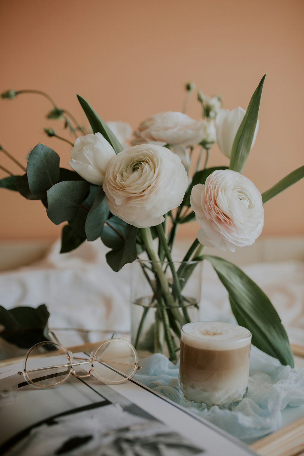 white roses in clear glass vase