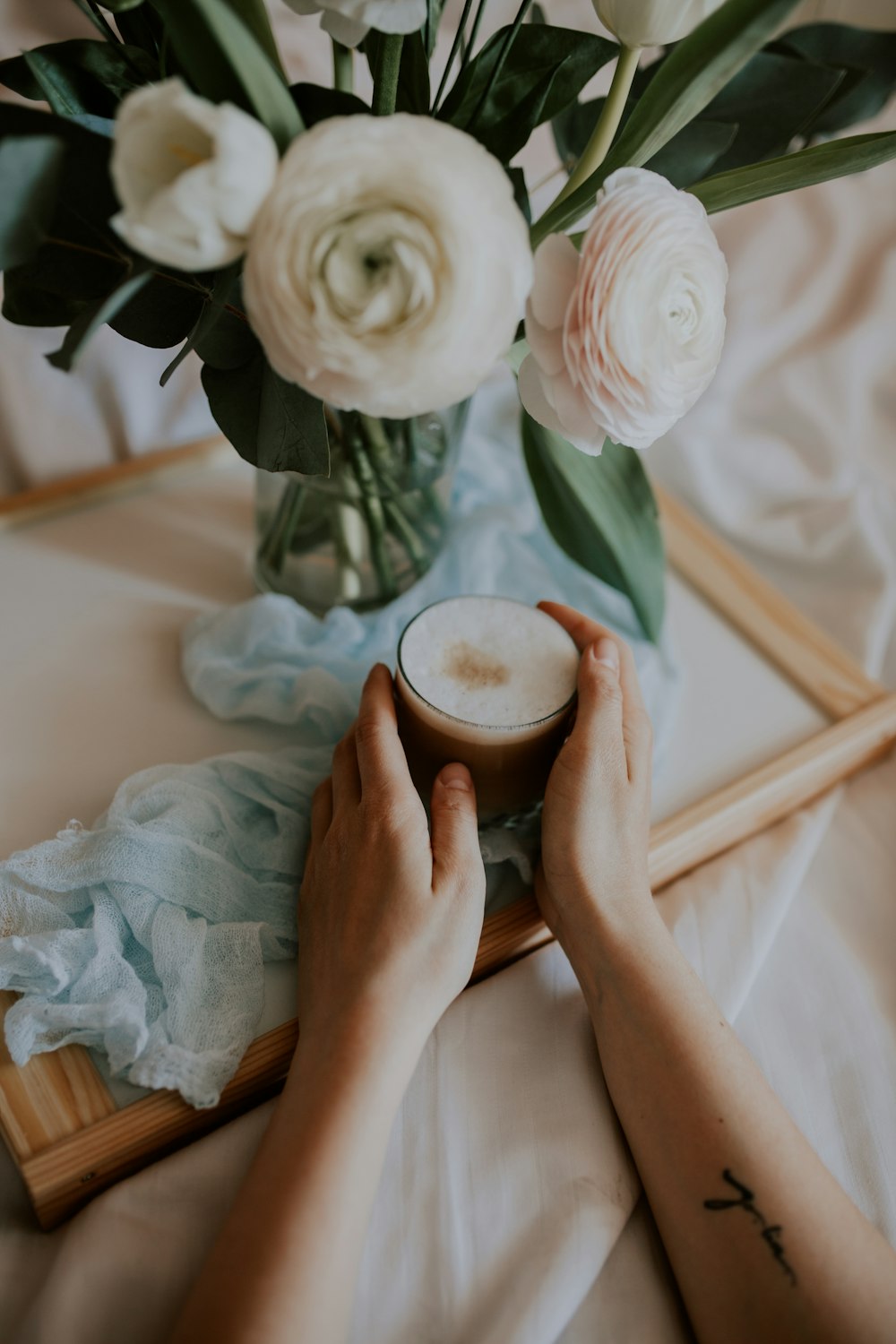 person holding white rose flower