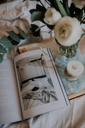 white ceramic teacup on white ceramic saucer on book page