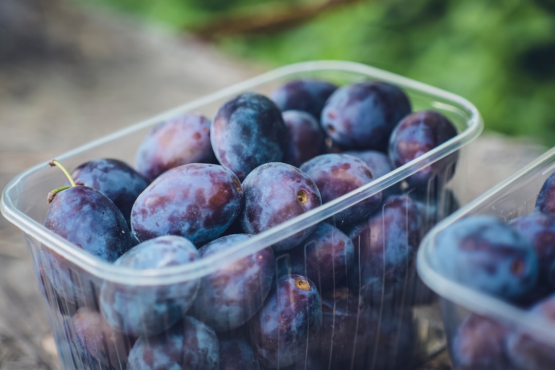 red round fruits on white plastic container