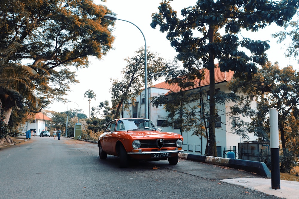 orange chevrolet car on road during daytime