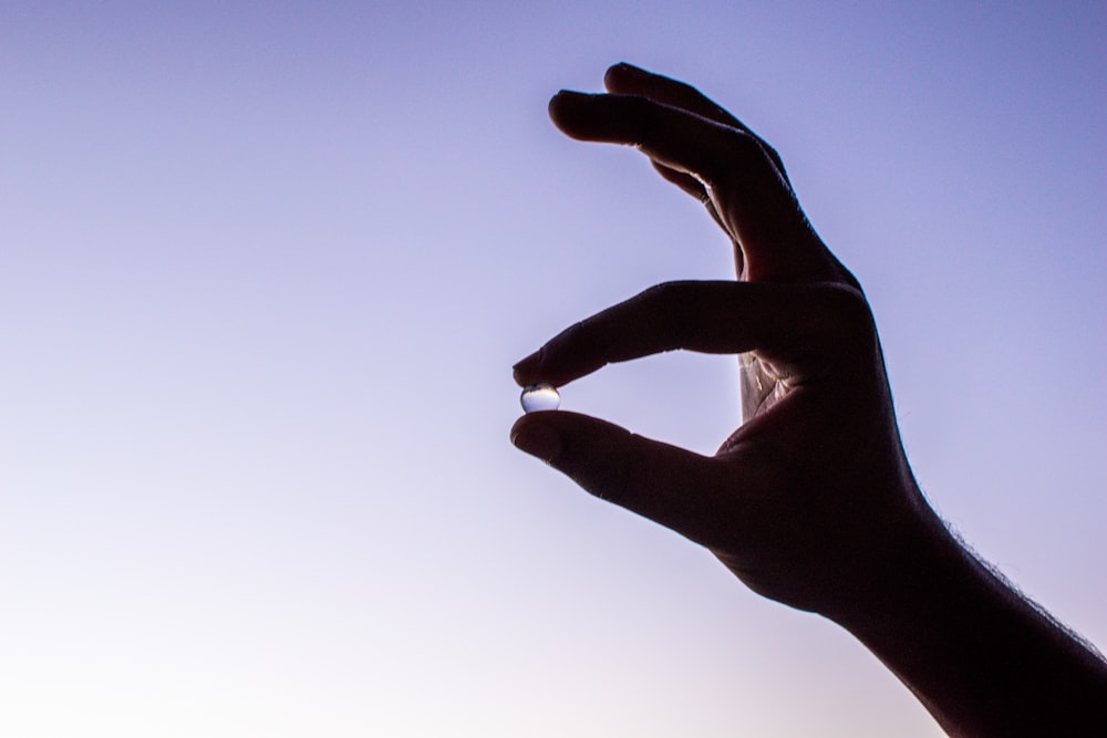 persons hand with white manicure