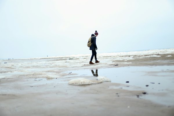 A walker alone on the frozen sand at Jūrmala in winter