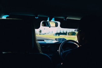 A close-up of a car windshield with a clear view of the road ahead.