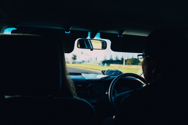 A close-up of a car windshield with a clear view of the road ahead.