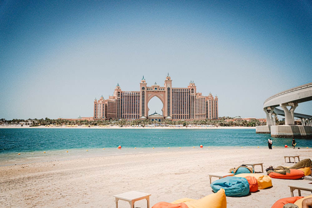 people on beach near bridge during daytime