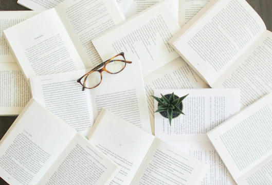 tortoiseshell glasses on open books