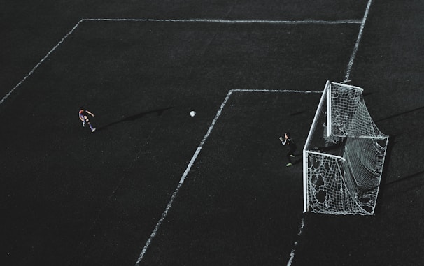 An epic shot of a youth soccer player celebrating a goal, with dramatic lighting.