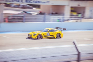 yellow and black porsche 911 on road