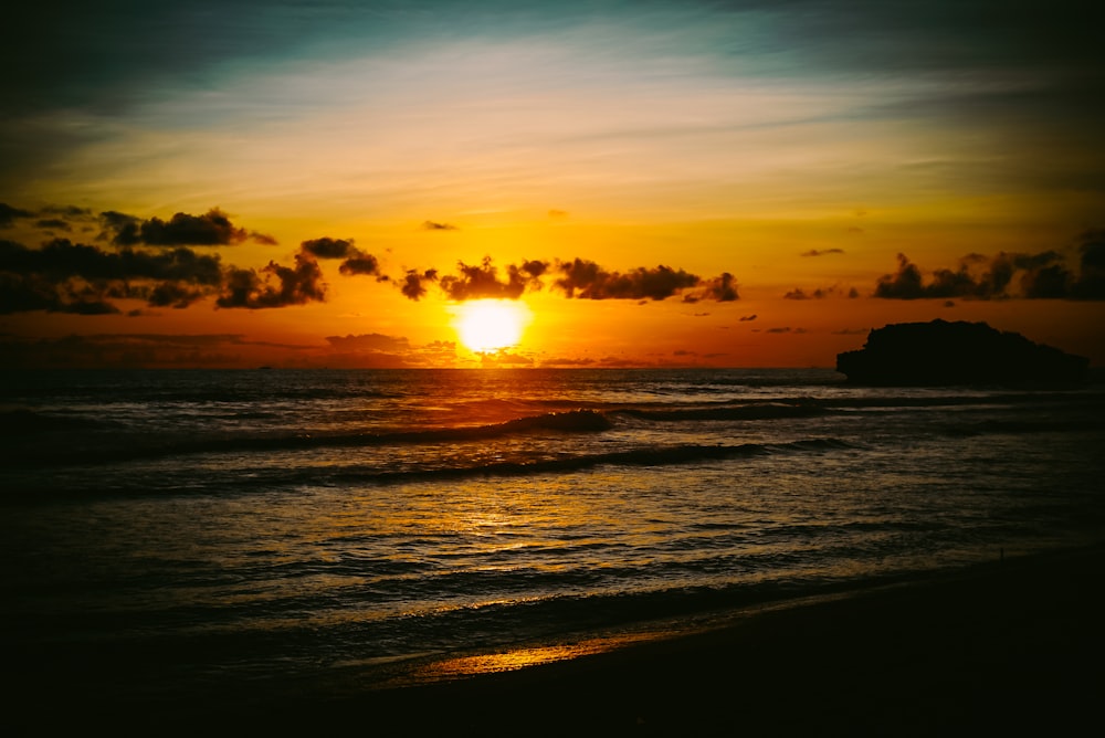 silhouette of people on beach during sunset