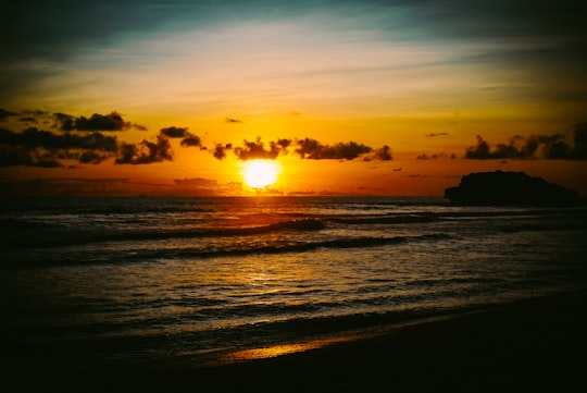 silhouette of people on beach during sunset in Pacitan Indonesia