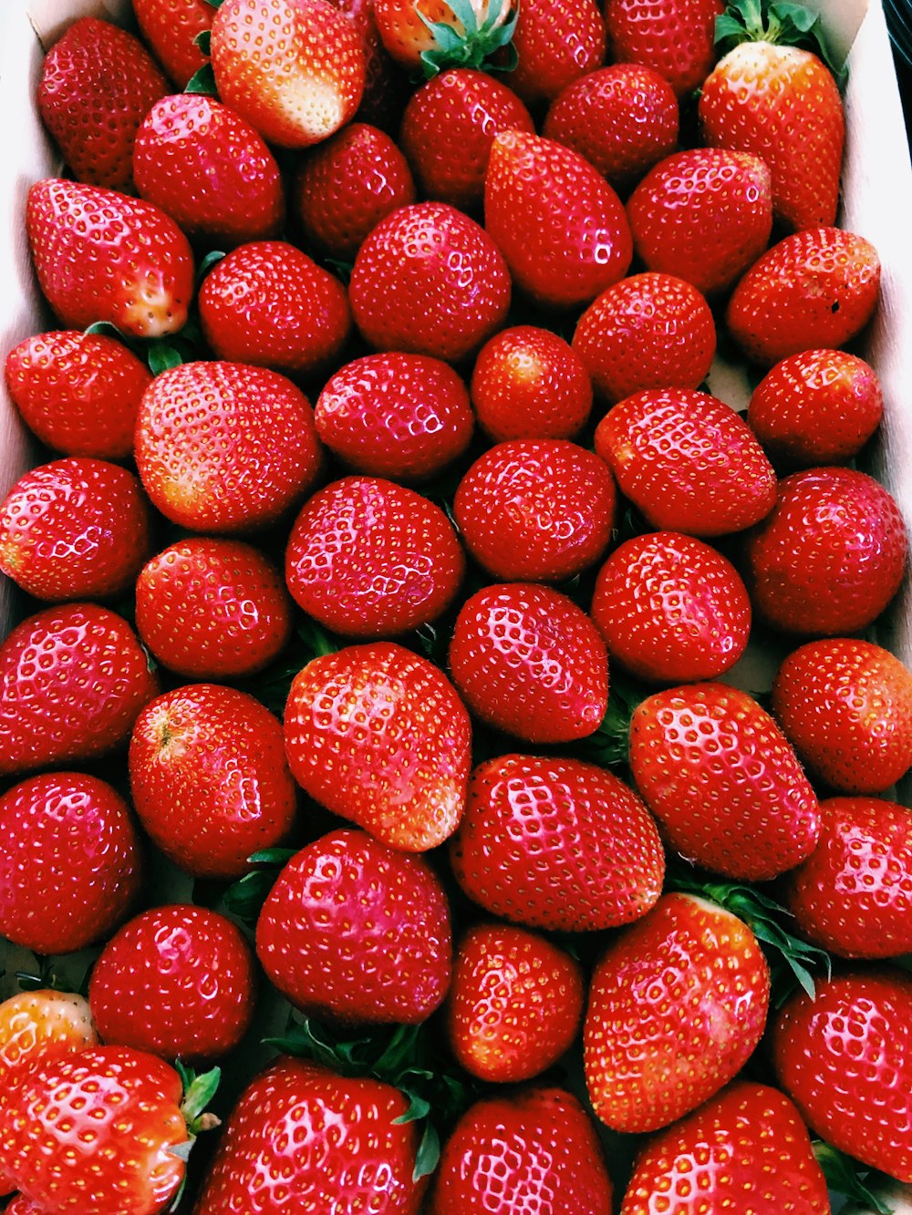 red strawberries on white ceramic plate