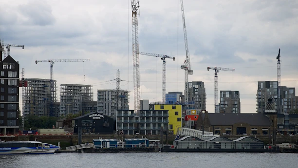 A sleek construction site in Halifax with cranes and modern buildings under development.