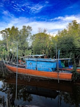 A vibrant photo of a sleek cabin cruiser docked at Norfolk Marine Service on Lake Erie under a clear blue sky.
