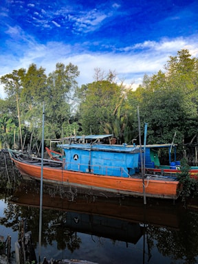 A vibrant photo of a sleek cabin cruiser docked at Norfolk Marine Service on Lake Erie under a clear blue sky.