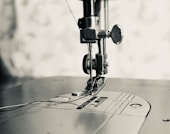 gray scale photo of sewing machine