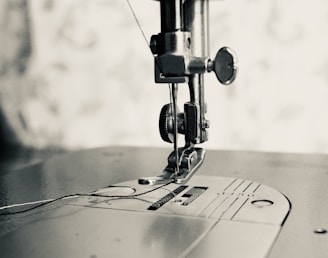 gray scale photo of sewing machine
