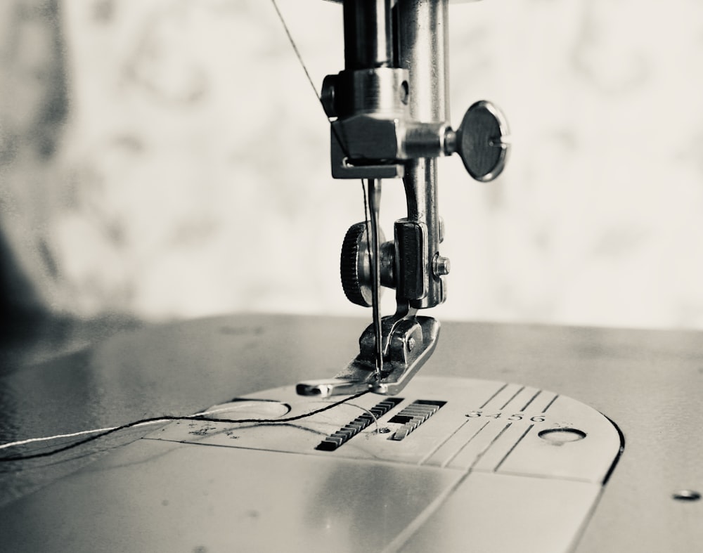 gray scale photo of sewing machine