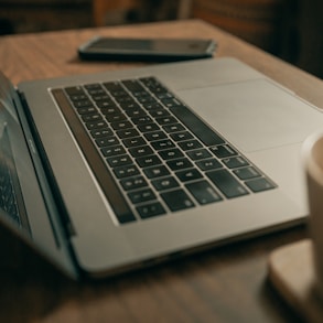 macbook pro on brown wooden table