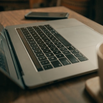 macbook pro on brown wooden table