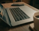macbook pro on brown wooden table