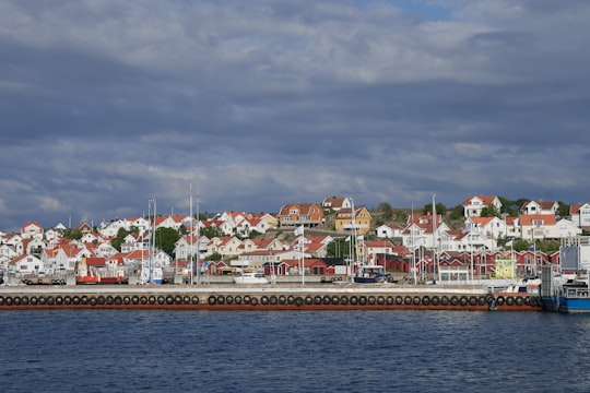 white and brown concrete building near body of water during daytime in Archipelago of Gothenburg Sweden