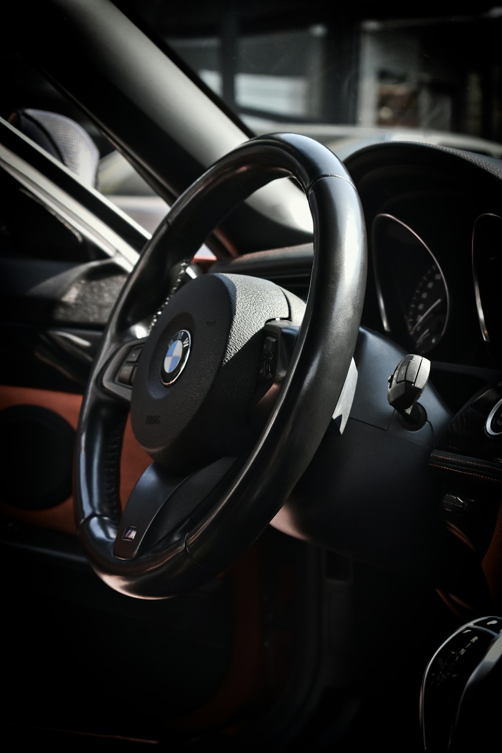 black and orange bmw steering wheel