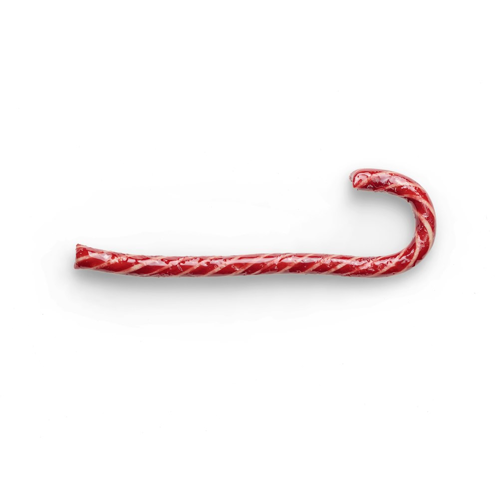 red candy cane on white background